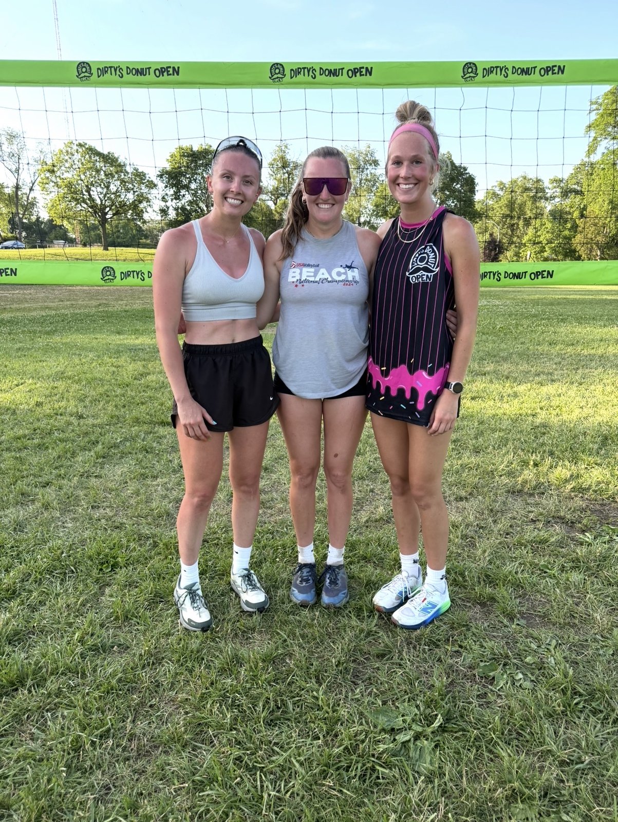 Three women in custom jerseys at the net at Dirty's Donut Open