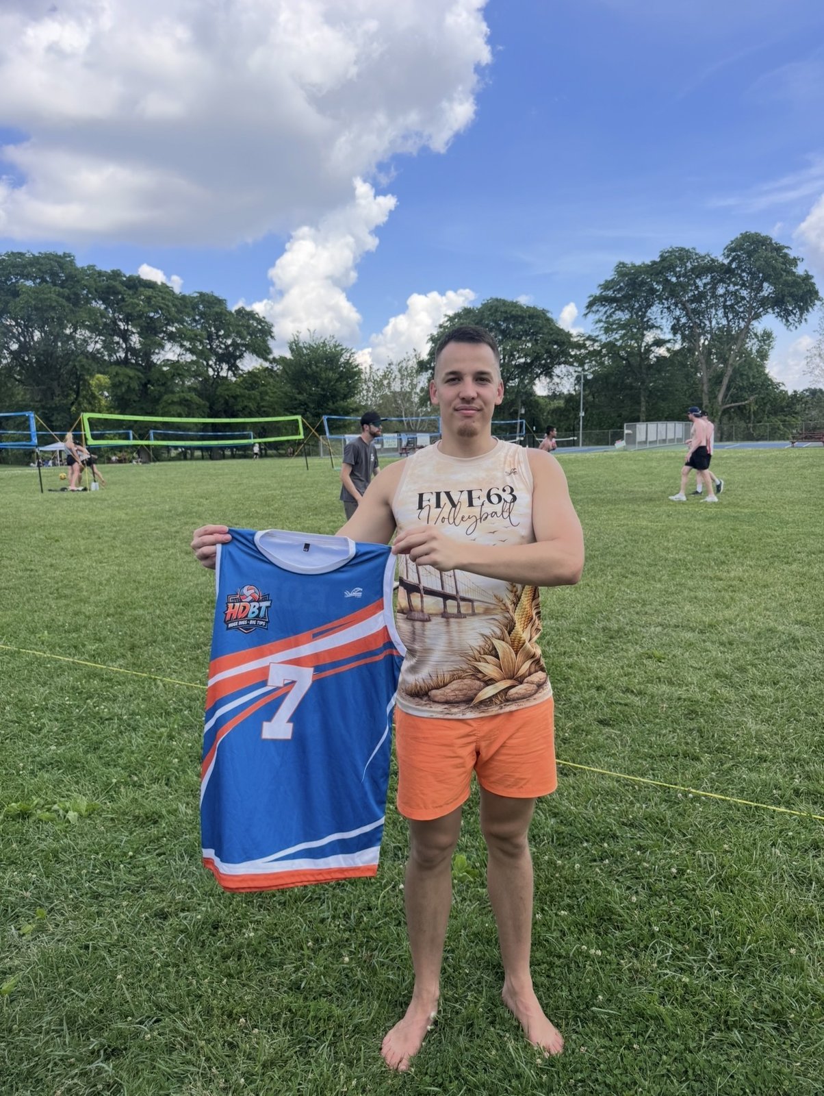 FIVE63 Volleyball player holding a custom jersey at Dirty's Donut Open