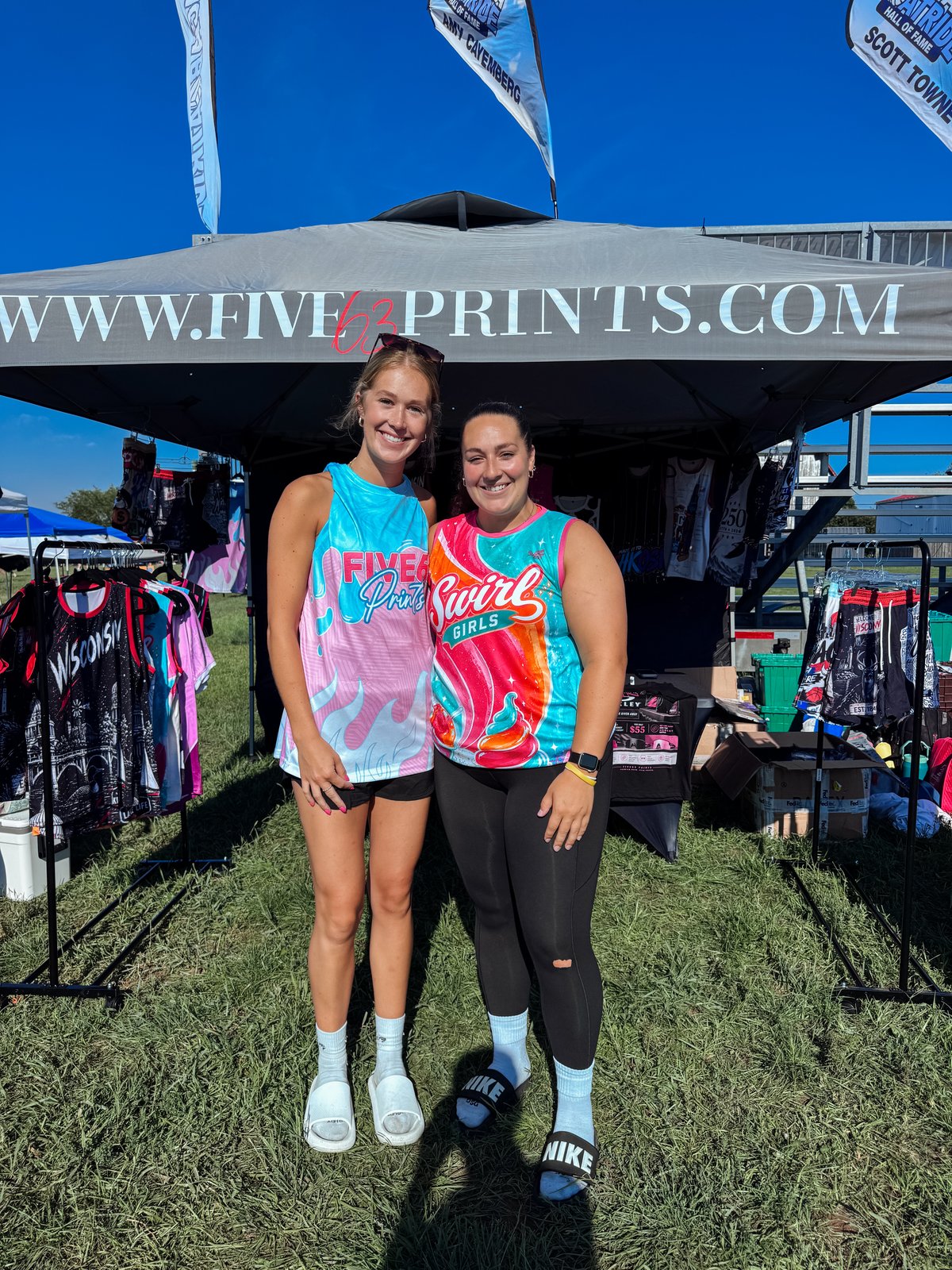 Two women wearing FIVE63 Prints and Swirl Girls custom jerseys